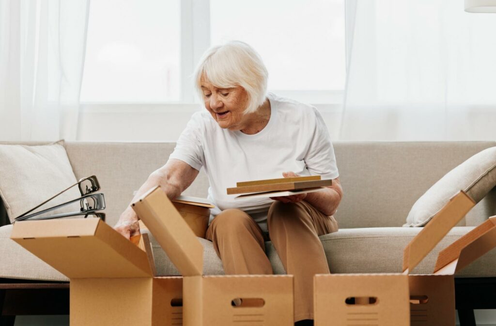 a senior sorts items into boxes